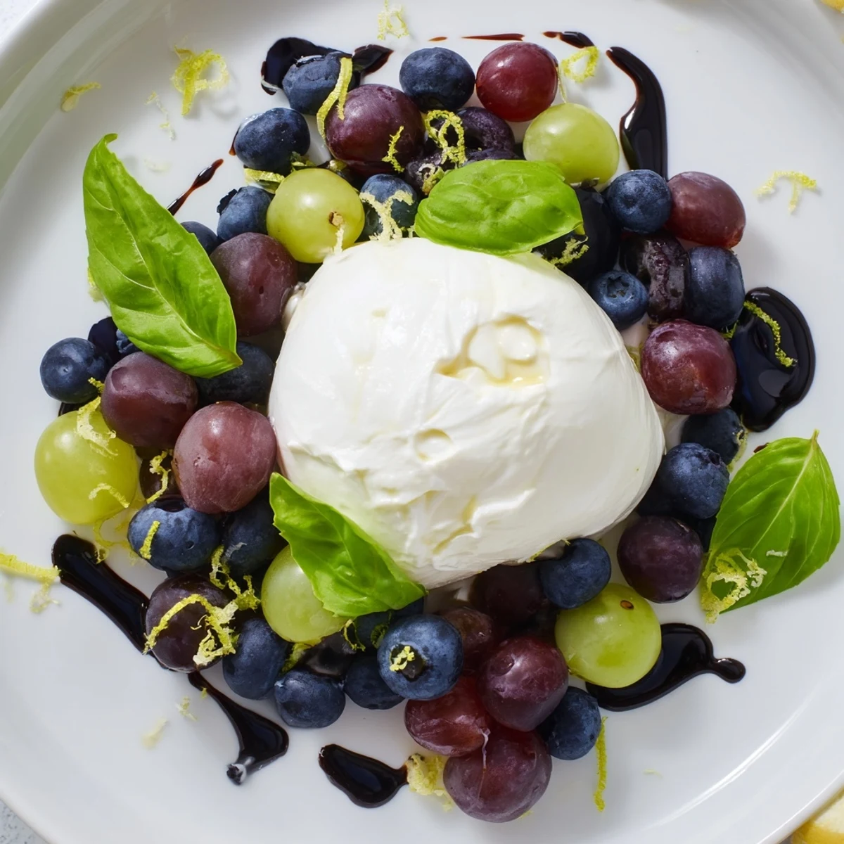 A visually stunning Moonlit Lagoon salad offers juicy grapes and blueberries with a delicate burrata center and basil.