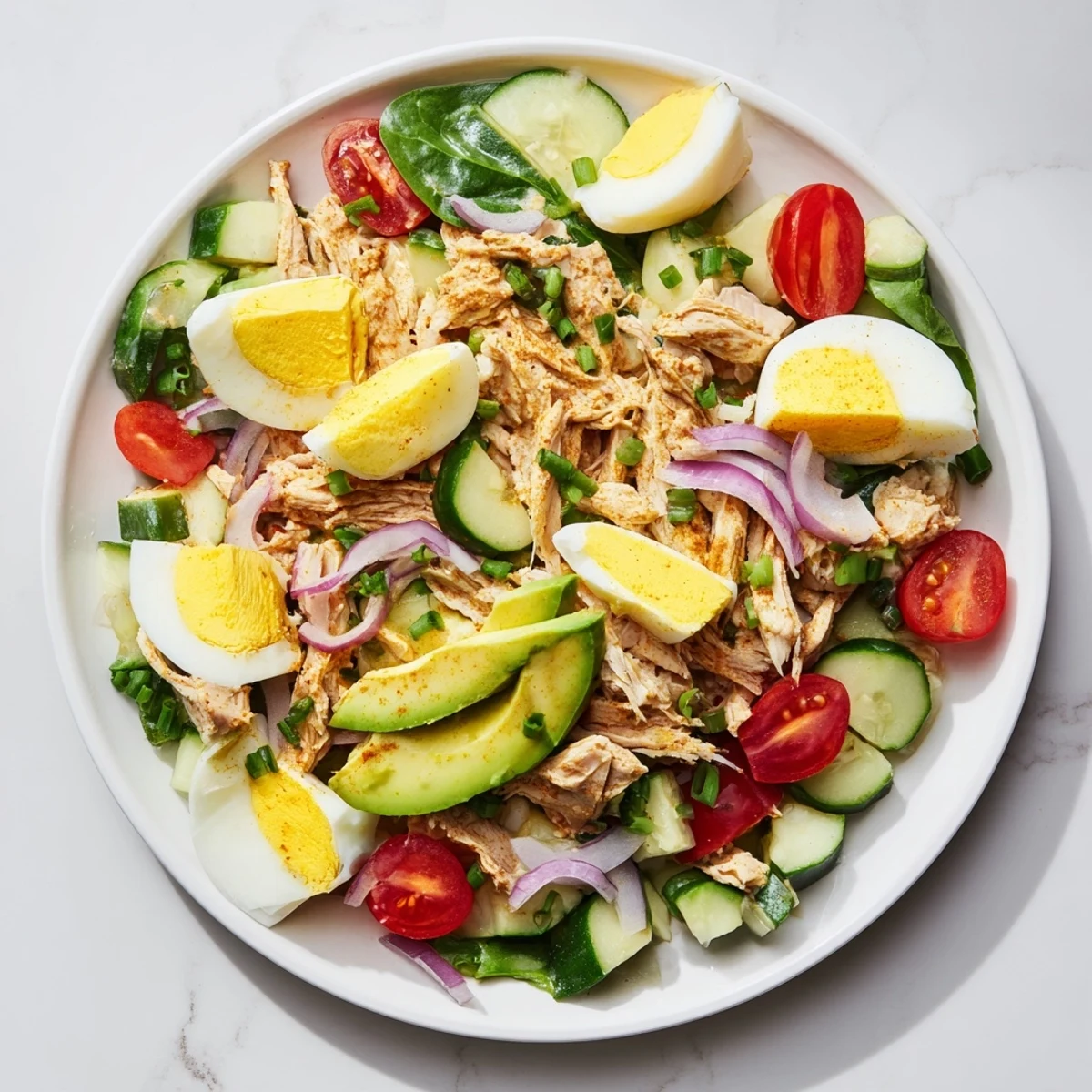 A close-up of a flavorful High-Protein Chicken and Egg Salad, ready to be served.