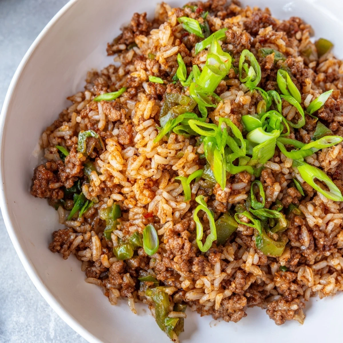 Steaming-hot Cajun Dirty Rice, a flavorful Southern dish with ground meat, vegetables, and rice.