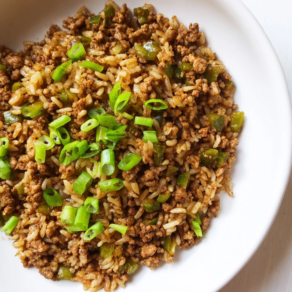 Savory and spiced Cajun Dirty Rice, cooked until the rice is tender and the flavors meld.