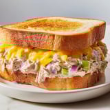 Melting cheddar and creamy tuna filling a perfectly grilled Classic Tuna Melt Sandwich, a satisfying comfort food.