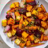 Tender, roasted root vegetable medley drizzled with balsamic glaze, a delicious vegetarian side.