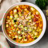 Hearty one-pot minestrone soup: brimming with pasta and garden-fresh vegetables, ready to eat.
