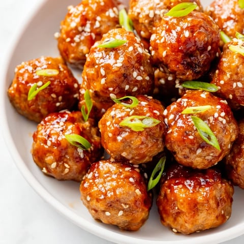Golden, glazed Spicy Sriracha Honey Meatballs ready to serve, a perfect sweet and savory appetizer.