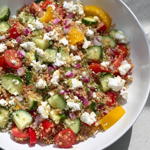 Make-Ahead Quinoa Salad with Lemon Vinaigrette showcases a colorful mix of ingredients, ready to eat.