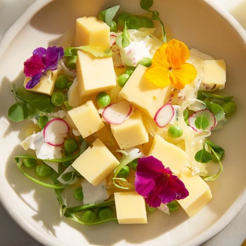A vibrant photo of "The Secret Garden" appetizer displays cheese cubes hidden under delicate flowers.