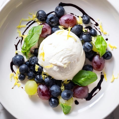Moonlit Lagoon salad: vibrant blueberries and grapes orbit creamy burrata, drizzled with balsamic glaze.