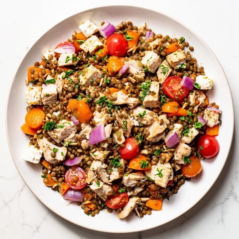 Chicken and Lentil Recession Salad bursting with colors of tomatoes and fresh parsley, chilled and ready.