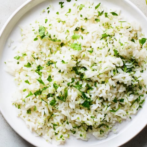 Fluffy cilantro lime rice, infused with citrus and cilantro— a vibrant side dish.