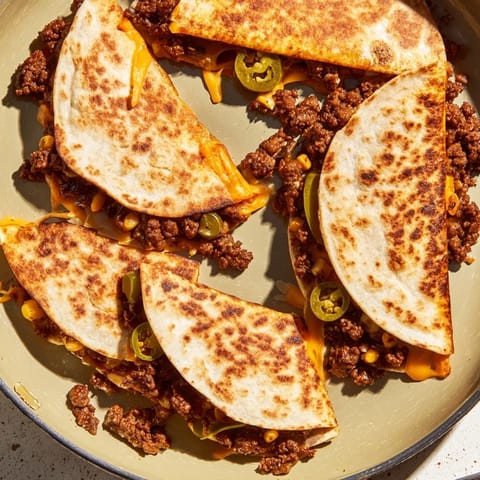 Crispy Sheet Pan Quesadillas, brimming with colorful veggies, are perfect for a quick, family dinner.