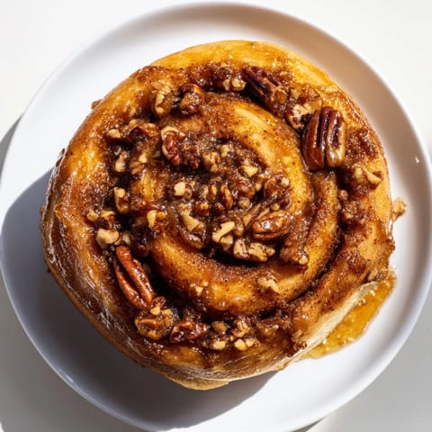 Warm, gooey Pecan and Honey Sticky Buns, featuring a rich honey caramel base, ideal for a sweet brunch treat.