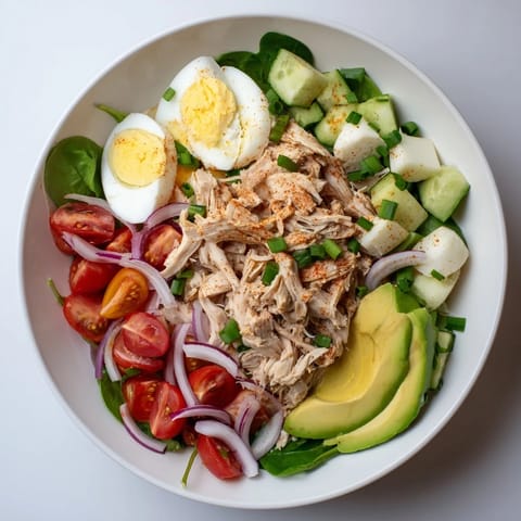 Creamy High-Protein Chicken and Egg Salad with bright red tomatoes, perfect for lunch.