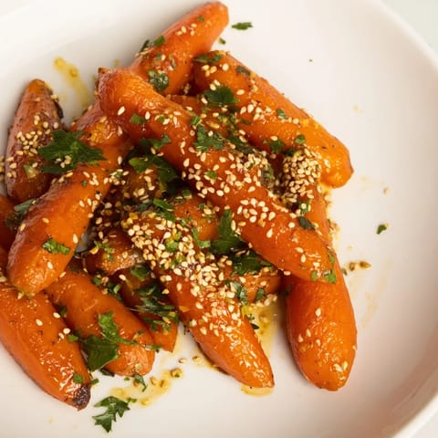 Tender, caramelized Maple Mustard Roasted Carrots arranged on a platter, ready to enjoy.