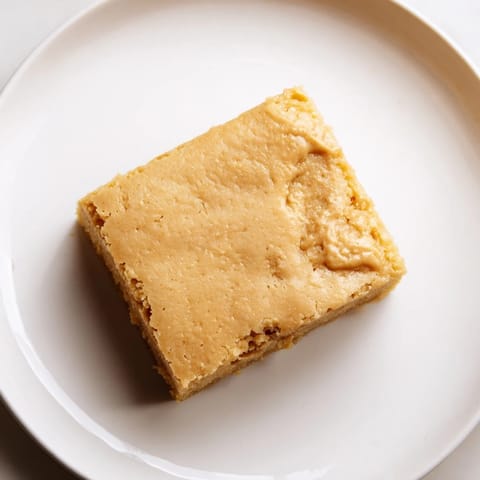 A pan full of freshly baked Peanut Butter Mochi Cake, ready to be sliced and served.