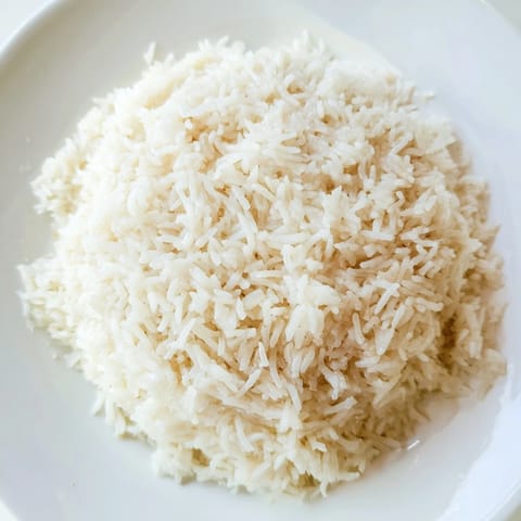 A close-up of fluffy Coconut Jasmine Rice showcases its delicate texture, ideal for Thai dishes.