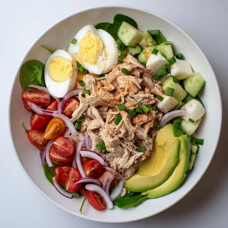 Creamy High-Protein Chicken and Egg Salad with bright red tomatoes, perfect for lunch.