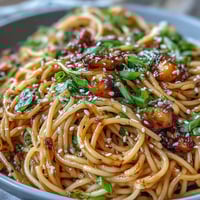 Creamy gochujang butter pasta with glossy, umami-rich sauce clinging to tender spaghetti strands.